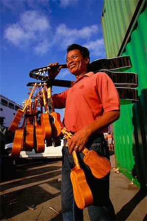 Man Selling Guitars and Ukuleles Cebu Port, Cebu City Philippines Stock Photo - Rights-Managed, Code: 700-00183746