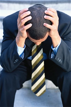 simsearch:700-00088934,k - Businessman Holding Head Stock Photo - Rights-Managed, Code: 700-00183899