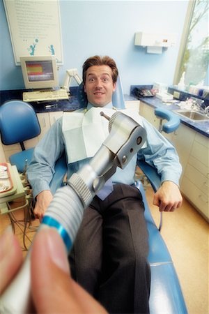 dentist with patient in exam room - Frightened Man in Dentist's Chair Stock Photo - Rights-Managed, Code: 700-00194618