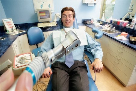 dentist with patient in exam room - Frightened Man in Dentist's Chair Stock Photo - Rights-Managed, Code: 700-00194619