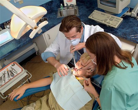 dentist with patient in exam room - Dentists Working on Boy Stock Photo - Rights-Managed, Code: 700-00194625