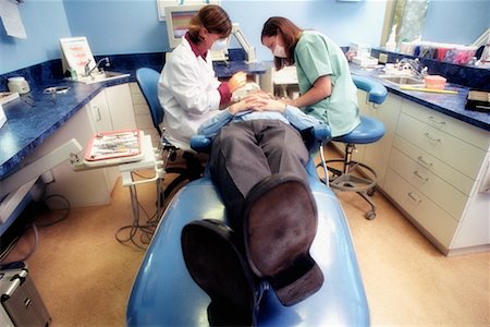 dentist with patient in exam room - Dentists Working on Patient Stock Photo - Rights-Managed, Code: 700-00194626
