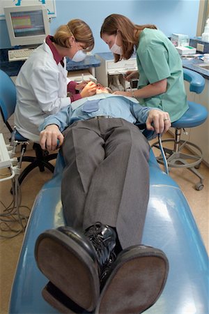 dentist with patient in exam room - Dentists Working on Patient Stock Photo - Rights-Managed, Code: 700-00194627