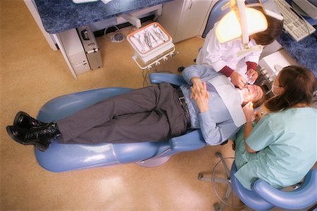 dentist with patient in exam room - Dentists Working on Patient Stock Photo - Rights-Managed, Code: 700-00194628