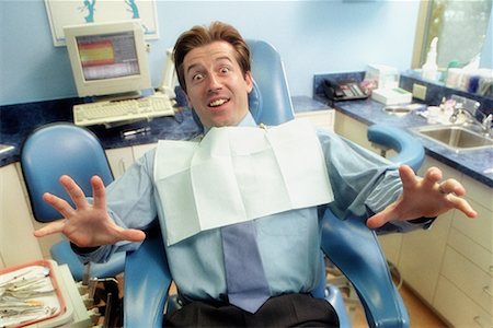 dentist with patient in exam room - Frightened Man in Dentist's Chair Stock Photo - Rights-Managed, Code: 700-00194620