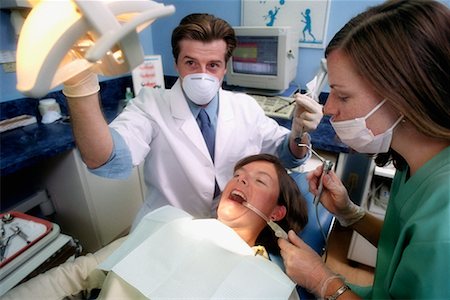 dentist with patient in exam room - Dentists Working on Patient Stock Photo - Rights-Managed, Code: 700-00194636