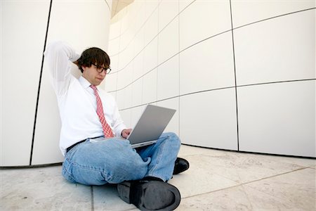 Man Working on Laptop in Hallway Stock Photo - Rights-Managed, Code: 700-00195814