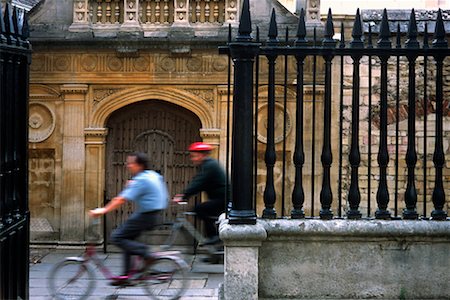 Cyclists Passing Building Cambridge, England Stock Photo - Rights-Managed, Code: 700-00196673