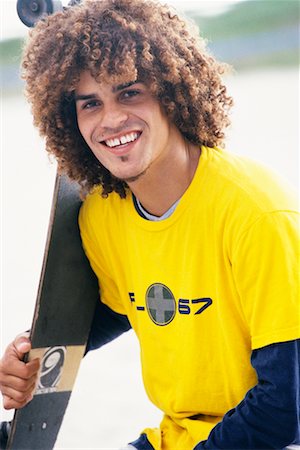 Portrait of Young Man with Skateboard Foto de stock - Con derechos protegidos, Código: 700-00197701