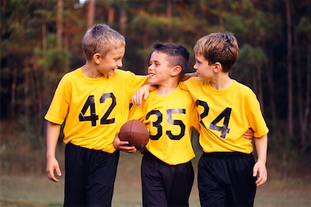 friends playing american football - Three Boys with Football Stock Photo - Rights-Managed, Code: 700-00198500
