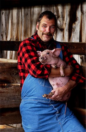 Farmer Holding Piglet Stock Photo - Rights-Managed, Code: 700-00198599