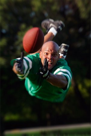 diving (not water) - Man Jumping to Catch Football Stock Photo - Rights-Managed, Code: 700-00199741