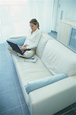 simsearch:700-00083403,k - Woman with Laptop on Sofa Stock Photo - Rights-Managed, Code: 700-00199789