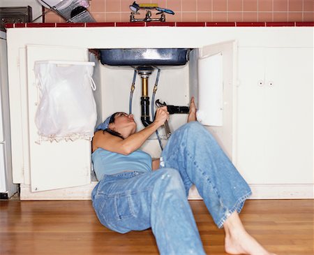 female plumber - Woman Repairing Sink Stock Photo - Rights-Managed, Code: 700-00267674