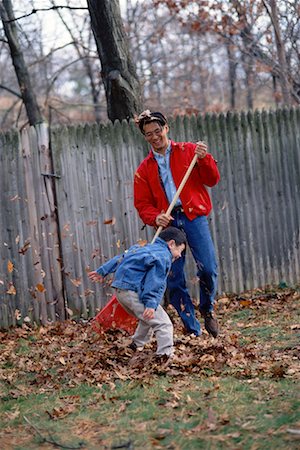 raking leaves autumn - Father and Son Raking Leaves Stock Photo - Rights-Managed, Code: 700-00263141