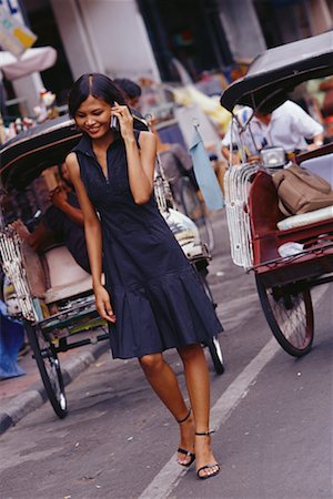 Woman with Cell Phone on Street Yogyakarta, Java Stock Photo - Rights-Managed, Code: 700-00286339