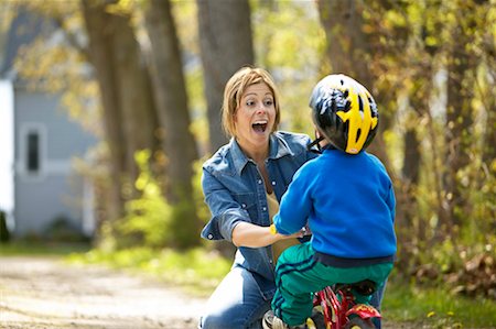 simsearch:700-03067843,k - Mother Helping Son Ride Bike Stock Photo - Rights-Managed, Code: 700-00345677