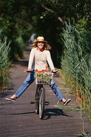 riding bike female basket - Woman Riding Bicycle Stock Photo - Rights-Managed, Code: 700-00342442