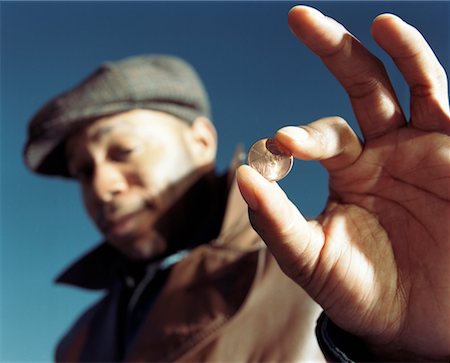 Man Holding Penny Stock Photo - Rights-Managed, Code: 700-00343094