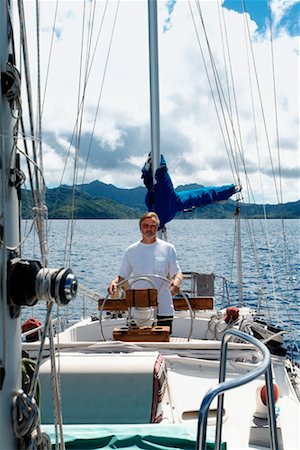 Man Handling a Ketch Rig Sailboat, Tahaa, French Polynesia Stock Photo - Rights-Managed, Code: 700-00361669