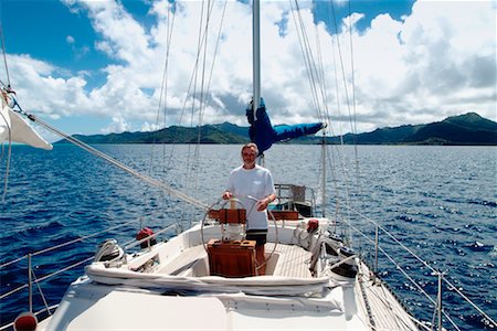 Man Handling a Ketch Rig Sailboat, Tahaa, French Polynesia Stock Photo - Rights-Managed, Code: 700-00361670