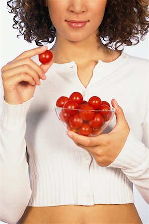Femme de manger des tomates cerises Photographie de stock - Rights-Managed, Code: 700-00403944