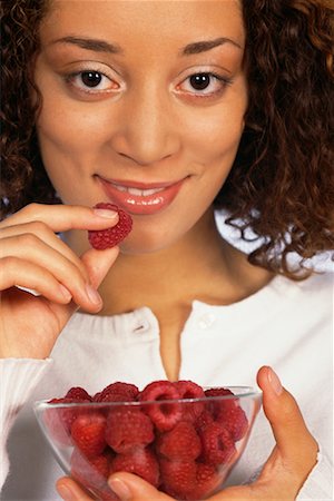 Woman Eating Raspberries Stock Photo - Rights-Managed, Code: 700-00403943