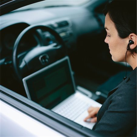 Businesswoman Using Laptop and Phone Stock Photo - Rights-Managed, Code: 700-00424481