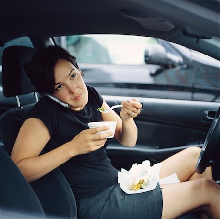 drive-thru - Téléphone cellulaire à l'aide de femme et manger dans la voiture garée Photographie de stock - Rights-Managed, Code: 700-00424482
