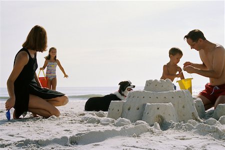 Family Building Sandcastle on The Beach Stock Photo - Rights-Managed, Code: 700-00439159