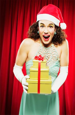 simsearch:700-00795365,k - Woman in Santa Hat Holding Gifts Stock Photo - Rights-Managed, Code: 700-00439497