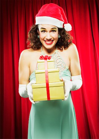 simsearch:700-00795365,k - Woman in Santa Hat Holding Gifts Stock Photo - Rights-Managed, Code: 700-00439498