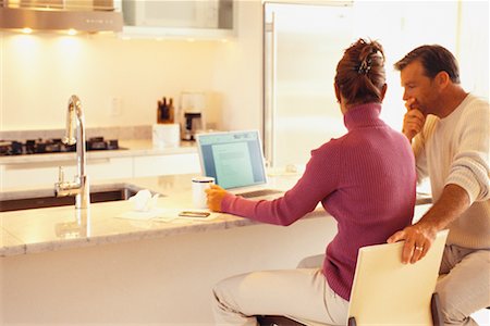 simsearch:700-00609233,k - Couple Doing Computer Banking in Kitchen Stock Photo - Rights-Managed, Code: 700-00439986