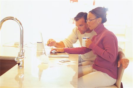 simsearch:700-00609240,k - Couple Doing Computer Banking in Kitchen Stock Photo - Rights-Managed, Code: 700-00439983