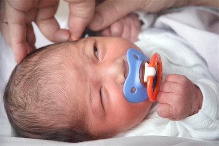 pediatric nursing - Hands Examining Ear of Newborn Stock Photo - Rights-Managed, Code: 700-00452664