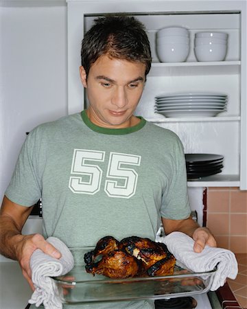 ruined food - Man Holding Burnt Dinner Stock Photo - Rights-Managed, Code: 700-00452741