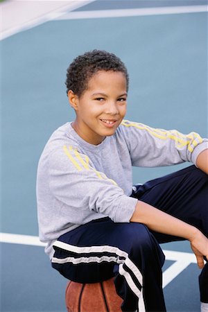 Portrait of Boy, Sitting On Basketball Stock Photo - Rights-Managed, Code: 700-00477813