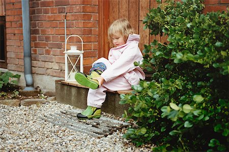 Girl Taking Off Boots Stock Photo - Rights-Managed, Code: 700-00506883