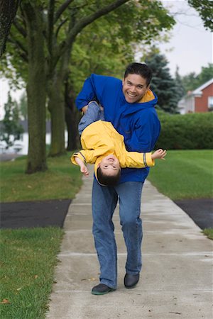 simsearch:700-06758135,k - Father Carrying Son Upside Down Stock Photo - Rights-Managed, Code: 700-00515212