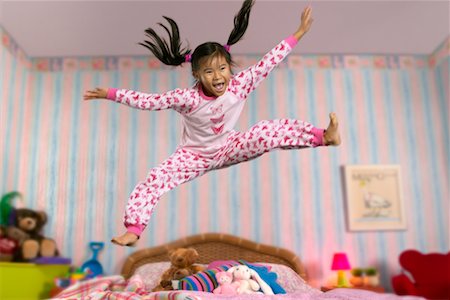Child Jumping on Bed Stock Photo - Rights-Managed, Code: 700-00519366