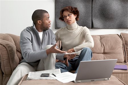 Couple in Living Room with Laptop and Newspaper Stock Photo - Rights-Managed, Code: 700-00524019