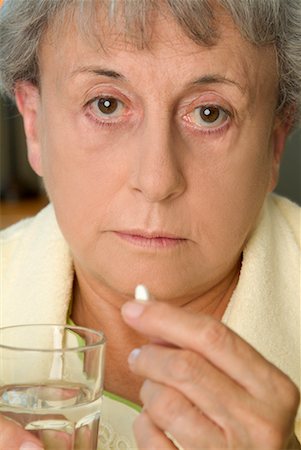 simsearch:6108-05867295,k - Portrait of Woman Taking Pill Stock Photo - Rights-Managed, Code: 700-00524911