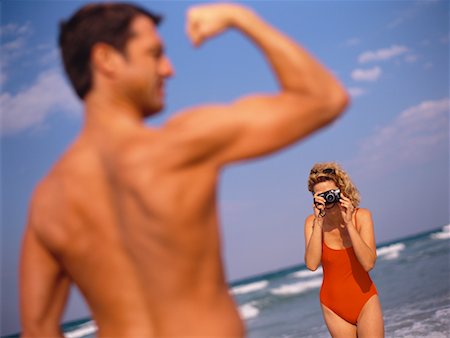 Woman Photographing Man on Beach Stock Photo - Rights-Managed, Code: 700-00528379