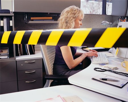 simsearch:700-01248157,k - Businesswoman Sitting at Desk, with Yellowtape across Workspace Stock Photo - Rights-Managed, Code: 700-00528786
