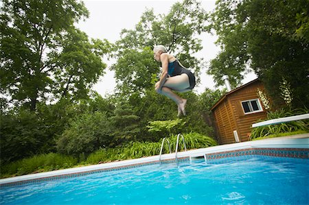 simsearch:700-00057270,k - Woman Jumping into Swimming Pool Stock Photo - Rights-Managed, Code: 700-00529206
