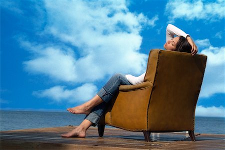 Woman Sitting in Chair on Dock Stock Photo - Rights-Managed, Code: 700-00520107