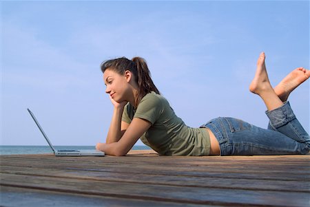 Woman Lying on Dock, Using Laptop Stock Photo - Rights-Managed, Code: 700-00520125