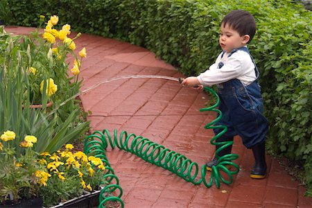 Boy Watering Garden Stock Photo - Rights-Managed, Code: 700-00522527