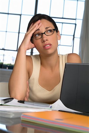 simsearch:700-00523344,k - Woman Sitting at Desk Looking Worried Stock Photo - Rights-Managed, Code: 700-00522851