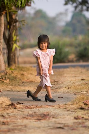 Girl Wearing Mother's Shoes Stock Photo - Rights-Managed, Code: 700-00523295